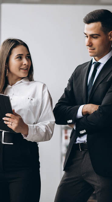 Male and female business people working on tablet in office